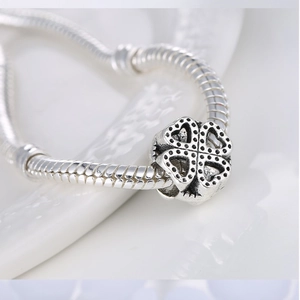 Silver four-leaf clover hollow charm bead on a snake chain bracelet for DIY jewelry making