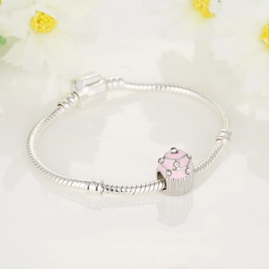 Silver snake chain bracelet with pink enamel cupcake charm and crystal accents