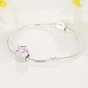Pink enamel cupcake charm on silver snake chain bracelet with white cubic zirconia