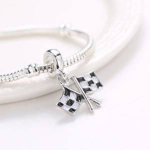 Close-up of checkered flag pendant with black and white enamel on silver snake chain