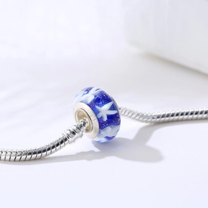 Blue starry glass star charm with S925 sterling silver stamp on a silver snake chain