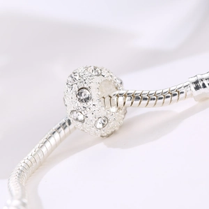 Silver bead charm with sparkling clear crystals on a metal snake chain bracelet
