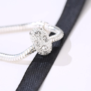 Silver bead charm with sparkling zircon inlay on snake chain bracelet for DIY jewelry