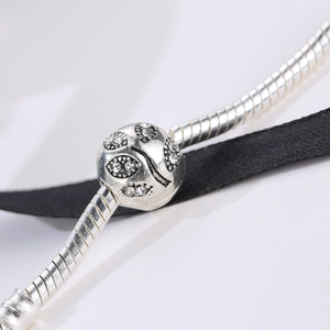 Silver snake chain bracelet featuring a leaf embossed bead with zircon crystals