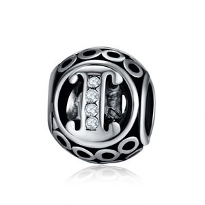 Macro detail of retro S925 silver charm bead featuring four inset cubic zirconia stones