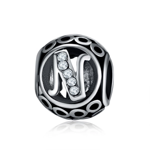 Macro shot of silver letter N charm bead with five cubic zirconia stones for DIY jewelry