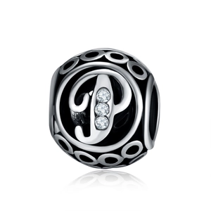 Detailed macro view of retro silver hollow charm bead with letter P and zircons