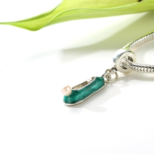 Green enamel Chinese flower shoe charm with pearl detail on silver snake chain bracelet