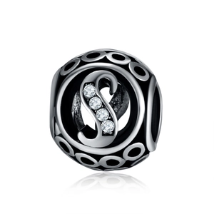 Detailed macro view of the hollow metal charm featuring letter S with sparkling zircons