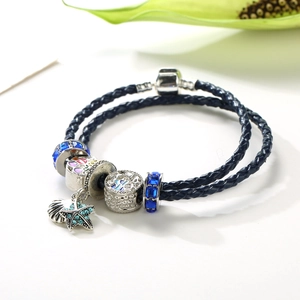 Blue leather double-layer ocean bracelet with starfish and seashell charms on white background