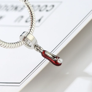 Red high heel pendant with pearl detail on silver snake chain bracelet