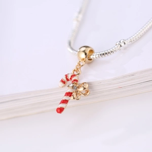 Christmas candy cane charm with red enamel and gold bow on silver snake chain bracelet