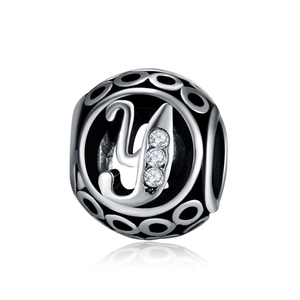 Macro detail of镂空 letter Y charm bead with sparkling white zircons for DIY jewelry