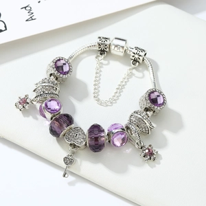 Detail view of purple crystal charm bracelet with silver snake chain and heart pendant