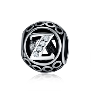 Macro shot of silver hollow charm bead featuring letter Z with inlaid zircon stones