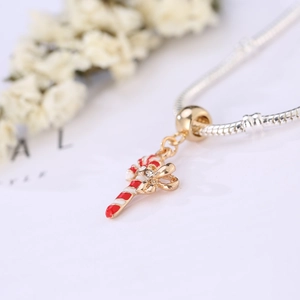 Silver snake chain bracelet with a festive red and white candy cane bow pendant