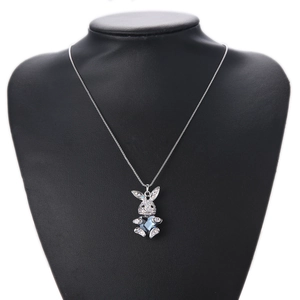 Easter rabbit necklace with blue heart crystal and silver chain on a black stand