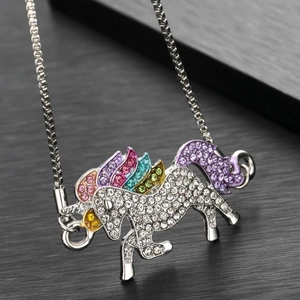 Macro view of a unicorn necklace pendant with multicolored rhinestones on a silver chain