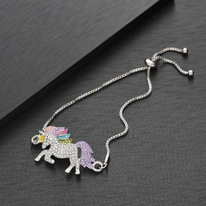 Macro shot of silver unicorn bracelet featuring colorful rhinestones and adjustable slider