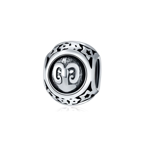 Macro detail of silver Aries zodiac charm bead with hollow stars for DIY jewelry making