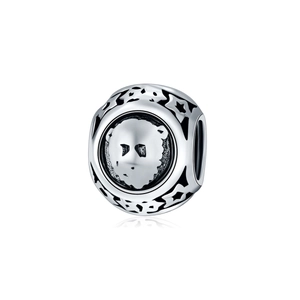 Detailed macro view of retro S925 silver cylinder charm with bear relief and star cutouts
