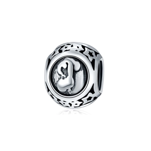 Macro shot of silver charm bead with hollow star patterns and 3D relief design