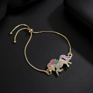 Detail of gold unicorn bracelet featuring colorful crystals and adjustable chain
