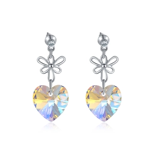 Detail of silver bow earrings with iridescent heart-shaped crystals and mirror reflection