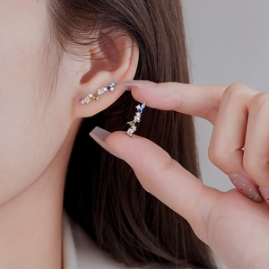 Minimalist silver stud earrings with colorful irregular cubic zirconia in a curved design