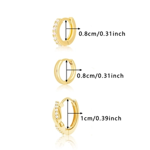 Detailed view of three gold huggie earrings with pink and white zircon stones in vertical stack