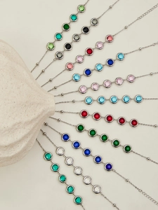 Macro shot of colorful round faceted glass stones on silver chains in a radial display