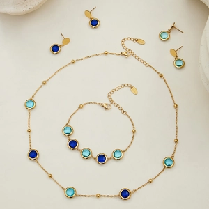 Bohemian gold jewelry set with faceted blue glass stones including necklace and earrings