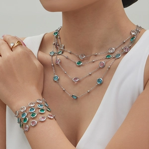 Layered silver necklace and bracelet set with round multicolor crystal gemstones
