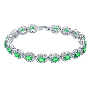Silver bracelet with oval green emerald stones and zircon halo in a luxury style