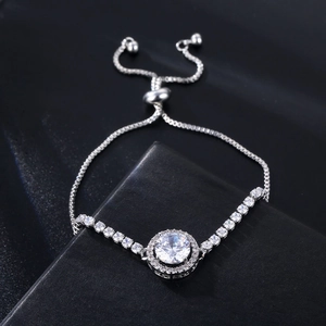 Detailed close-up of a silver adjustable bolo bracelet with a sparkling halo pavé crystal