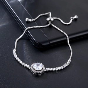 Close-up of adjustable silver pull-chain bracelet with halo-set round crystals and box chain