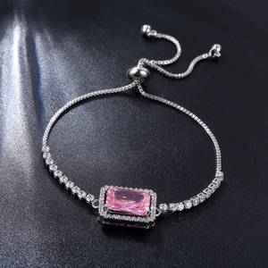 Macro detail of silver bolo bracelet with rectangular pink zircon and halo setting