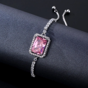 Macro detail of adjustable silver bracelet featuring a large rectangular pink zircon stone