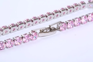 Macro detail of a pink square-cut zircon tennis bracelet with a secure insert clasp