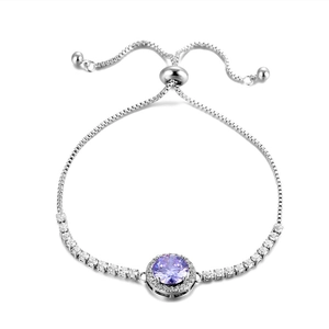 Detail of adjustable silver slider bracelet featuring a round purple zircon with halo
