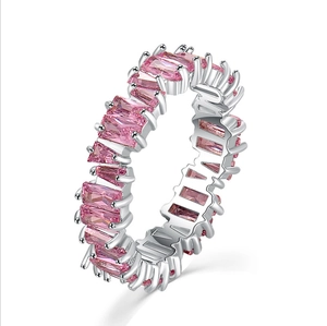 Pink baguette-cut zircon eternity ring in silver finish shown from a 45-degree angle