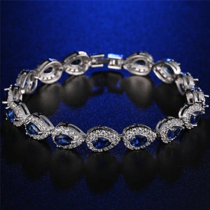 Silver bracelet with teardrop-shaped blue gemstones and micro-pave cubic zirconia crystals