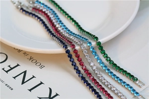 Close-up of five colorful tennis bracelets with round-cut cubic zirconia in claw setting