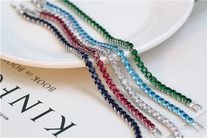 Detail view of silver tennis bracelets with colorful round-cut cubic zirconia and box clasp