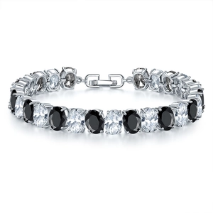 Detail view of oval cut black and white zircon bracelet with silver metal and fold-over clasp