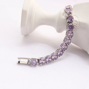 Elegant tennis bracelet featuring round purple zircons in a polished silver-tone setting.