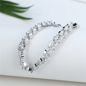Elegant silver leaf bracelet with marquise-cut cubic zirconia on a white pedestal