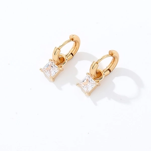 Detailed view of gold earrings with princess-cut square clear cubic zirconia crystals