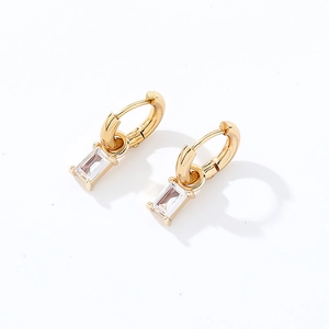 Detailed shot of gold hoop earrings featuring rectangular cubic zirconia pendants