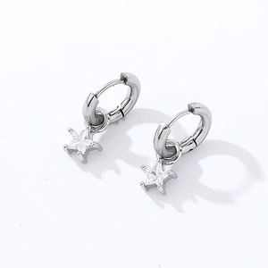 Detail shot of silver star drop earrings featuring clear cubic zirconia in a prong setting